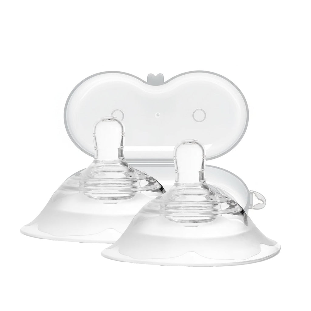 Clear baby feeding nipples on a white background