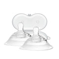 Clear baby feeding nipples on a white background